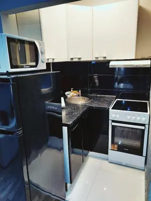 a small kitchen with a microwave and a sink at Top Belgrade Apartments in Belgrade