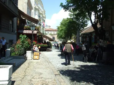 a man walking down a street with a cane at Enjoy Belgrade in Belgrade