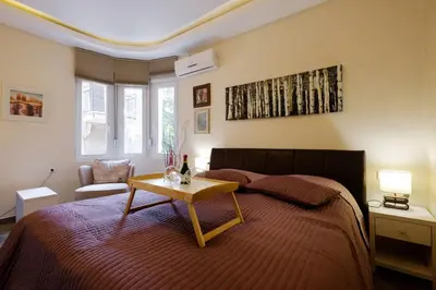 a bedroom with a bed with a table on it at Enjoy Belgrade in Belgrade