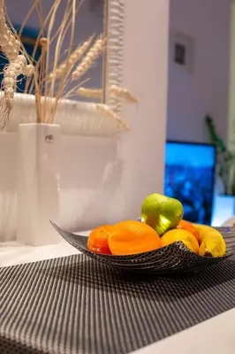 a bowl of fruit on a table with a knife at Belville Luxury Apartment in Belgrade