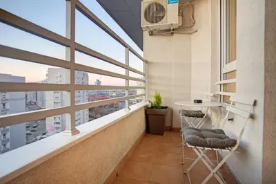a balcony with a table and chairs in a building at Belville Luxury Apartment in Belgrade