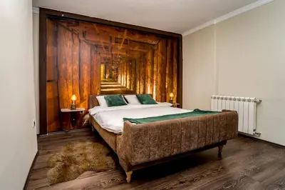 a bedroom with a large bed and a wooden wall at French House in Belgrade