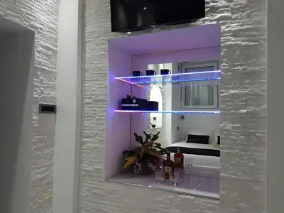 a room with a mirror with purple lights on it at Monroe Apartment in Belgrade