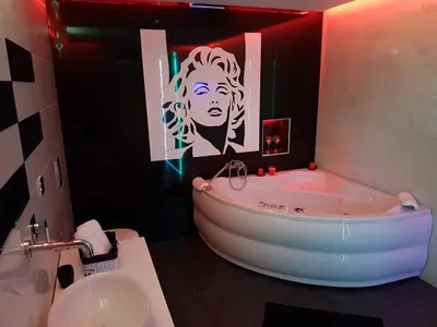 a bathroom with a tub and a sink in it at Monroe Apartment in Belgrade