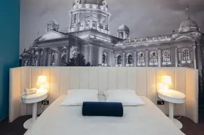 a bed in front of a large building at Passport Belgrade in Belgrade