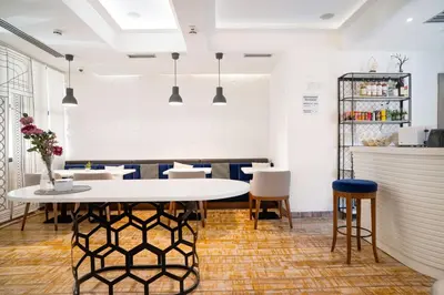 a dining room with a white table and chairs at Passport Belgrade in Belgrade