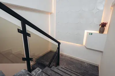 a staircase in a house with white walls and black railings at Passport Belgrade in Belgrade