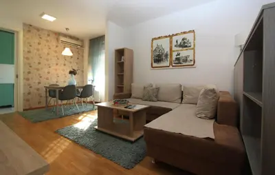 a living room with a couch and a table at Twin Belville Apartments in Belgrade