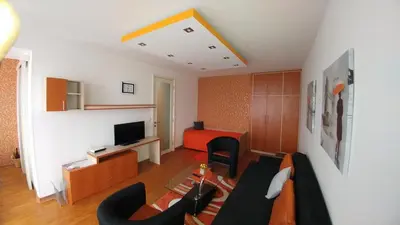a living room with a couch and a television at Twin Belville Apartments in Belgrade