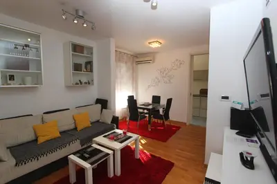 a living room with a couch and a table at Twin Belville Apartments in Belgrade
