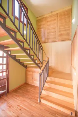 a staircase in a house with wooden floors and wooden walls at Green House Hostel in Belgrade