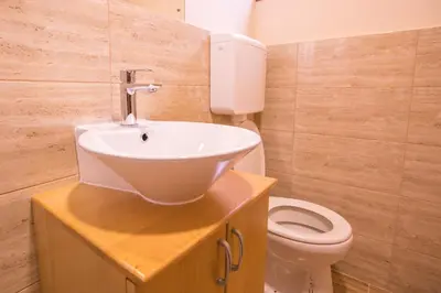 a bathroom with a sink and a toilet at Green House Hostel in Belgrade