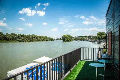 a balcony with a view of a river at Green House Hostel in Belgrade