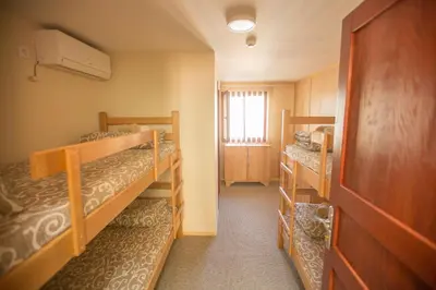 a room with two bunk beds and a window at Green House Hostel in Belgrade