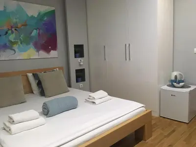 a bedroom with a white bed with towels on it at L9 Top Central Rooms and Apartments 2 in Belgrade