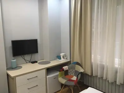 a room with a desk with a television and a chair at L9 Top Central Rooms and Apartments 2 in Belgrade
