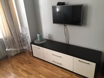 a flat screen tv hanging on a white wall at L9 Top Central Rooms and Apartments 2 in Belgrade