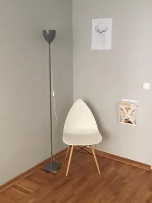 a white chair and a lamp in a room at L9 Top Central Rooms and Apartments 2 in Belgrade