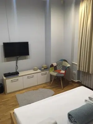a room with a tv and a chair and a bed at L9 Top Central Rooms and Apartments 2 in Belgrade