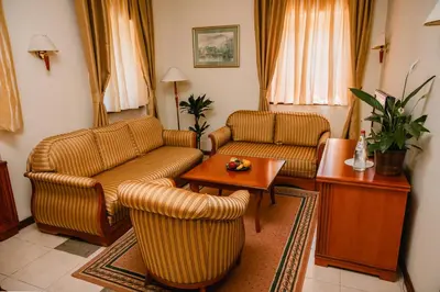 a living room with two couches and a table at Kaštel Ečka in Ečka