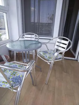 a table and two chairs and a glass table and chairs at Danube Apartment in Belgrade
