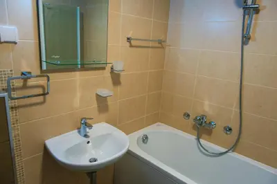 a bathroom with a sink and a tub and a shower at Maja Apartment in Belgrade