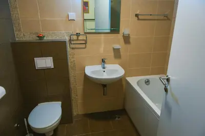 a bathroom with a toilet and a sink and a tub at Maja Apartment in Belgrade