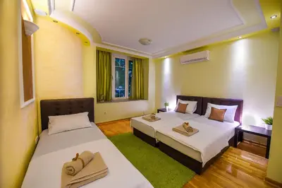 a room with two beds with towels on them at Apartment Sweet House Politika in Belgrade