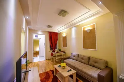 a living room with a couch and a table at Apartment Sweet House Politika in Belgrade