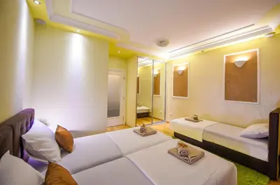 a large room with two beds and a mirror at Apartment Sweet House Politika in Belgrade