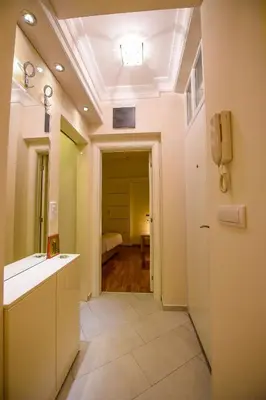a bathroom with a sink and a phone on the ceiling at Apartment Sweet House Politika in Belgrade