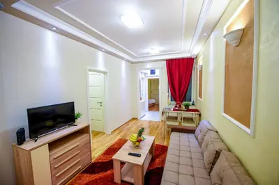 a living room with a couch and a tv at Apartment Sweet House Politika in Belgrade