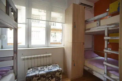 a dorm room with bunk beds and a window at Stella Di Notte in Belgrade