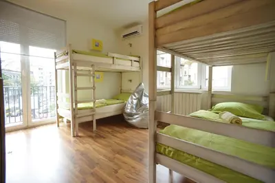 a room with three bunk beds in a building at Stella Di Notte in Belgrade