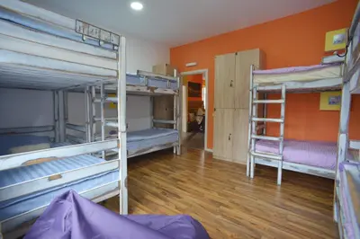 a room with three bunk beds and a wooden floor at Stella Di Notte in Belgrade