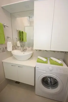 a bathroom with a washing machine and a sink at Apartment Mina in Belgrade