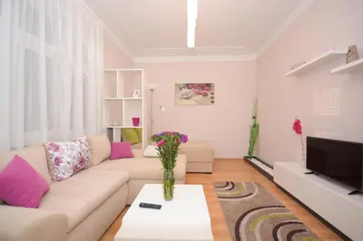 a living room with a couch and a tv at Apartment Mina in Belgrade