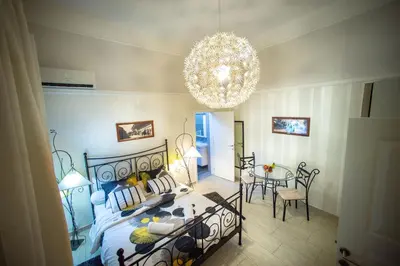 a bedroom with a bed and a chandelier at Central charm modern 2br apt-Free parking near in Belgrade
