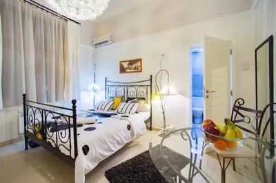 a bedroom with a bed and a table with a bowl of fruit at Central charm modern 2br apt-Free parking near in Belgrade