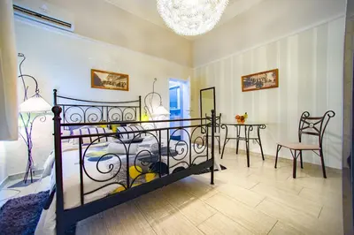 a bedroom with a bed and a table and chairs at Central charm modern 2br apt-Free parking near in Belgrade