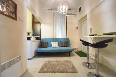 a living room with a blue couch and a table at Central charm modern 2br apt-Free parking near in Belgrade