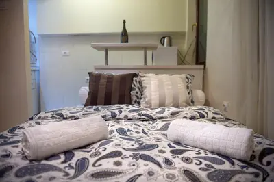 a bed with two pillows on top of it at Central charm modern 2br apt-Free parking near in Belgrade