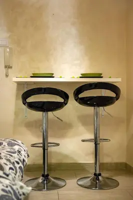 a table with two bar stools under a table at Central charm modern 2br apt-Free parking near in Belgrade