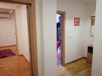 a room with a door open to a living room at Shumice Apartment in Belgrade
