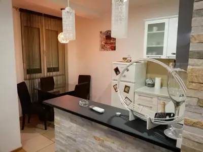 a bathroom with a mirror on a counter at Shumice Apartment in Belgrade