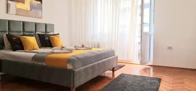 a bedroom with a bed with two teddy bears on it at Downtown Star Apartment in Belgrade