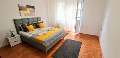 a bedroom with a large bed with two towels on it at Downtown Star Apartment in Belgrade