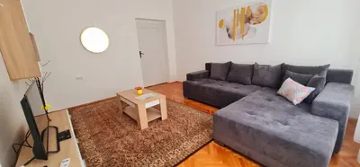 a living room with a couch and a table at Downtown Star Apartment in Belgrade