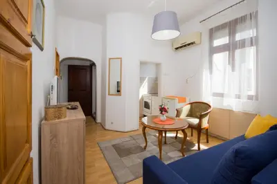 a living room with a blue couch and a table at Downtown Star Apartment in Belgrade