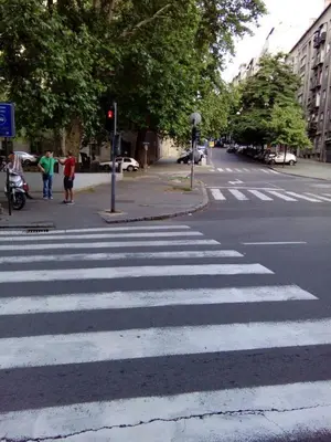a crosswalk on a street with people walking on the sidewalk at Apartment Zindan in Belgrade